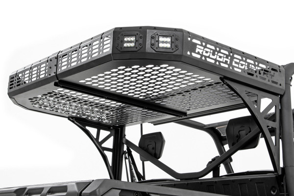 Overland adventures demand reliable cargo space. With Rough Country's Rear Cargo Rack Kit, you can increase your Can-Am Defender's storage capabilities without compromising bed space or dumping functionality. This rugged, heavy-duty steel rack is built to withstand any challenge, ensuring durability and strength through every adventure.Engineered for Toughness & Protection: Constructed from heavy-duty steel, this cargo rack boasts a corrosion-resistant, powder-coated finish that protects against the harshest elements. No matter the terrain, the IP67 waterproof design ensures that your gear stays safe from water, dust, and dirt. This kitΓÇÖs versatile mesh pattern includes multiple tie-down points, providing flexibility to secure all your gear without worry.Seamless & Hassle-Free Installation: Enjoy a quick and easy setup with 100% bolt-on installationΓÇöno drilling, no cutting, just a secure, factory-like fit. Plus, the full dump bed functionality remains intact, so you can haul heavy loads or dump with ease. For those nighttime adventures, you can opt for two pairs of 2-inch flush mount Cree LED lights, offering superior visibility and durability.Durable & Long-Lasting: Whether you're navigating rugged landscapes or navigating daily tasks, Rough CountryΓÇÖs rear cargo rack kit provides unmatched reliability and toughness. With years of protection and a design built to last, itΓÇÖs the ultimate upgrade for your Can-Am Defender.