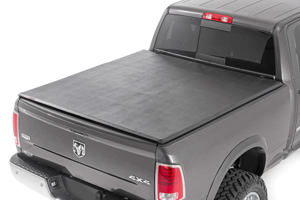 Want to streamline your ride and protect your gear from the elements? Look no further than Rough Country's Tri-Fold Vinyl Tonneau Cover! With its durable construction and easy installation, it's the perfect addition to any truck.\
Tri-fold Design for Style and Efficiency: This tonneau cover folds up in three sections for easy access to your bed whenever you need it. Need to haul a large item? Simply fold back a panel. When everything's loaded up, unfold it completely for a sleek look that can also improve your gas mileage.\
Security & Weatherproof Seal: Sitting firmly on the bed railing and featuring a heavy-duty vinyl construction with an all-weather seal, our tri-fold cover keeps your gear safe from prying eyes and the elements.\
Durable Construction: Crafted with a lightweight 6061 aluminum frame, this cover is tough enough to handle whatever rough terrain you throw at it while keeping your gear safe and sound.\
Effortless Installation: Our cover comes completely assembled in the box, no loose parts, no tools required. Thanks to our patented quick clamp system, you'll be ready to hit the road in no time.\
Protect your gear and streamline your ride with Rough Country's Tri-Fold Vinyl Tonneau Cover!