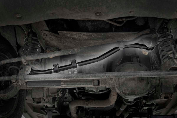 When you're way off the beaten path the last thing you should worry about is how you're getting home. Introducing Rough Country's Forged Adjustable Track Bar for Jeep WJ. This massive 17lb Track Bar is nearly twice the weight of your WJ's factory Track bar, offering you unparalleled support and the ultimate peace of mind in any driving situation.For those who are serious about pushing your lifted WJ to the limits, Rough Country's Forged Adjustable Track Bar is a must. This new track bar is made of forged steel and features rubber durable rubber bushings and a beefy construction that will dwarf stock equipment. This design allows the bar to keep your axles tame even under pure off-road torture.Best of all, it's simple to install and even easier to adjust! As you lift a Jeep, the axles become off centered. This new Forged Adjustable Track Bar gives you the ability to adjust and re-center the axles while mounted to the vehicle. This bolt-on product can be attached in just minutes giving you a nearly instant upgrade.While many aftermarket track bars are adjustable, Rough Country's new bar is fully adjustable on the vehicle; meaning no removal required, no trial and error lining it up, and no more wasted time just to dial in your bar. Simply attach to the vehicle and dial in your adjustable bar using our clamp and sleeve system.