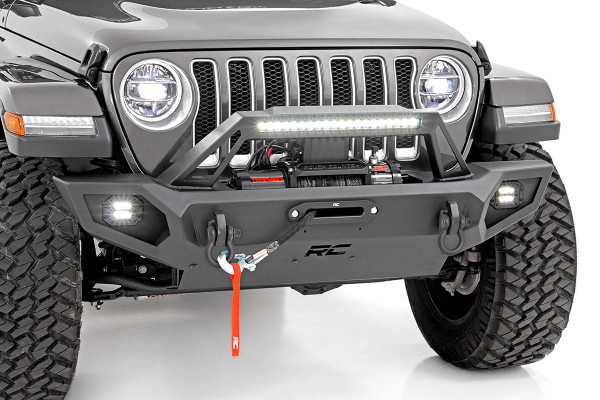 Transform the look and capabilities of your Jeep with Rough CountryΓÇÖs Full Width Trail Bumper. This full-width version of our fan-favorite Stubby Trail Bumper includes a few extra features youΓÇÖre sure to enjoy!\
Rough CountryΓÇÖs Jeep LED Trail Bumper has been engineered with a full-width design that fits in nicely with the factory flare or aftermarket modifications. With Jeep adding turn signals to the factory flares on JL and JT models, a full-width bumper can help lend an aggressive off-road look to your Jeep even when retaining the factory flare.\
Each kit includes a modular integrated fog light mount that allows you to run the included Rough Country 2-inch flush-mount led cubes. This front bumper also features a built-in Rough Country 20in Single-Row Black-Series LED Light Bar, providing 7,200 lumens and 100 watts of forward-facing illumination to help you easily see the trail ahead.\
Rough CountryΓÇÖs Full-Width Trail Bumper also features a set of D-ring shackles for a convenient recovery point, as well as a winch plate allowing you to install any standard-sized winch. A protective skid plate ensures unbeatable protection in off-road environments. If youΓÇÖre looking for one of the best Jeep bumpers available, look no further!