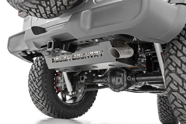 Protect your JLΓÇÖs Muffler from off-road hazards with Rough CountryΓÇÖs Muffler Skid Plate. This durable, 3/16 plate steel skid helps to protect your muffler from rocks, debris and anything else you can throw at it! The Jeep JLΓÇÖs exposed muffler is a vulnerable weak-spot when rock crawling or traversing uneven terrain. Fortify this area with a layer of plate steel protection and gain incredible peace of mind on your next trip out on the trails!This easy upgrade looks great, too, featuring a laser-cut ΓÇ£Rough CountryΓÇ¥ logo with an angled design and port holes for proper airflow and heat dissipation. With a 100% bolt-on installation procedure, this upgrade is easy to install as well, and features Rough CountryΓÇÖs Limited Lifetime Warranty.