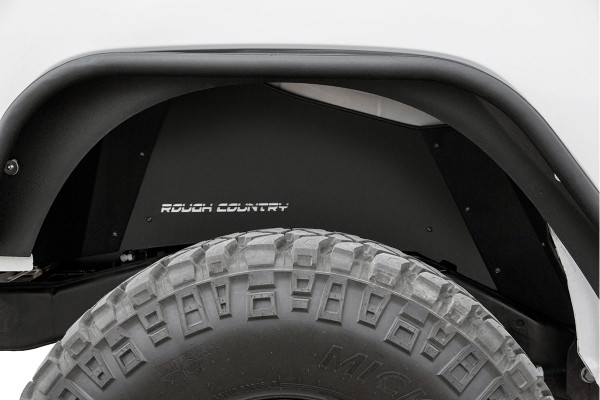 Clean up the look of your inner fenders when using aftermarket flares with Rough CountryΓÇÖs JK Rear Inner Fender Liners. This eye-catching inner fender upgrade helps protect sensitive areas from dust, mud, and debris, and can be easily installed in no-time flat!Aftermarket fenders are a huge improvement for most Jeeps wanting to get the best clearance and articulation possible, but when removing the stock fenders many people also remove the stock fender liners. With a unique 3-piece construction, these liners cover more areas than other liners on the market, giving more protection to your body panels. Each Rough Country liner features a corrosion-resistant powder coat for long-lasting durability. Additionally, these liners mount firmly to the body for quiet operation, free of rattling or vibration noise.The solid-steel, angular design with ΓÇ£Rough CountryΓÇ¥ logo cutouts gives an aggressive look to this now more visible area on your JK. The rear liner lines up perfectly to show the painted body color behind the cutout logo. Rough Country Inner Fender Liners feature a bolt-on installation process with minor drilling for an easy upgrade you can do with common tools in a home garage. Includes Rough CountryΓÇÖs Lifetime Replacement Warranty.