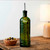 Olive Branch 16oz Recycled Glass Oil or Vinegar Bottle w/ Pour Spout Vintage Green with Olives and Lamp on Side Table