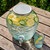 2 Gallon Bee Quenched Glass Beverage Dispenser - 100% Recycled Glass Above View of Infused Cucumber Lemon Water on Picnic Table with Bee Glass