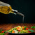 16.9 oz Tuscany Oil or Vinegar Bottle with Gold Spout Pouring Olive Oil on Salad