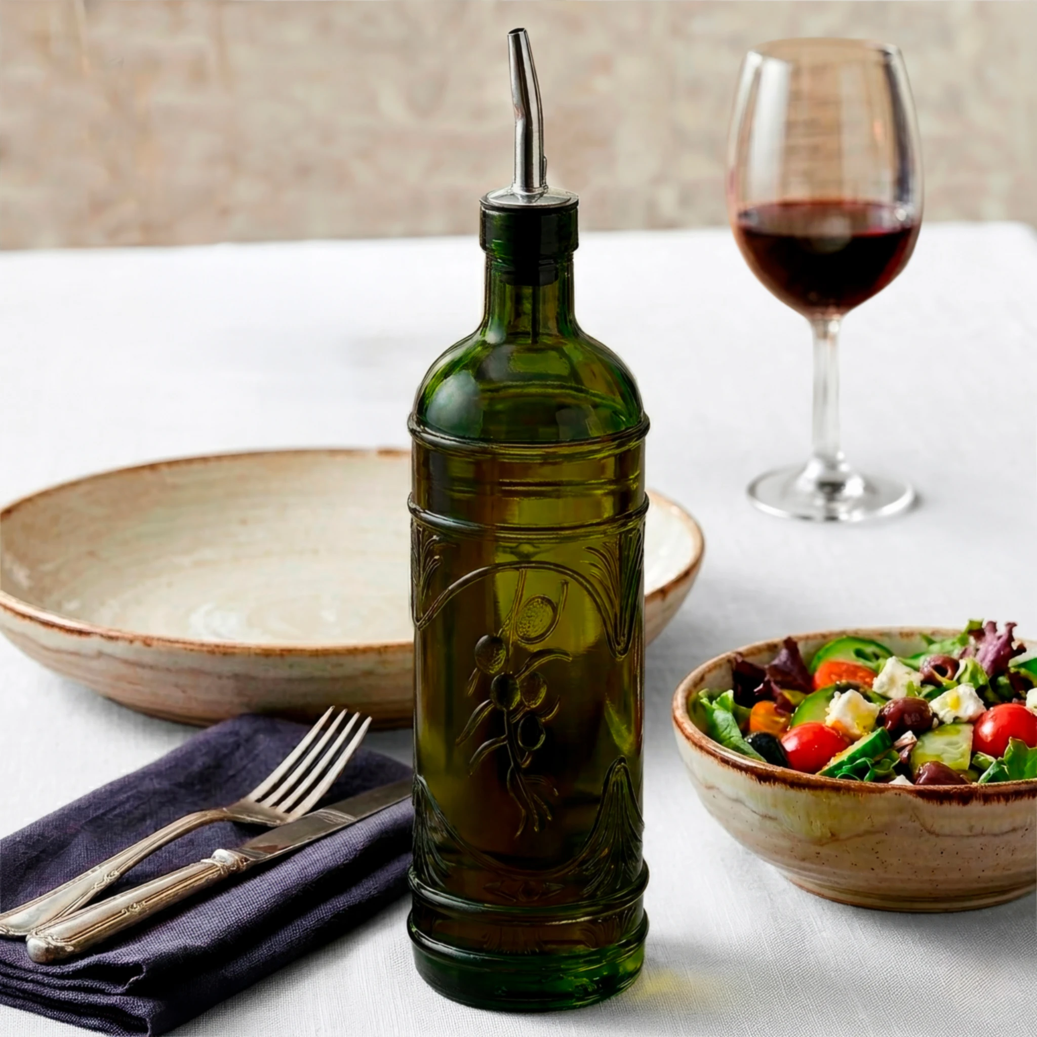 Olive Branch Oil Bottle Vintage Green at Outdoor Restaurant with Salad and Red Wine