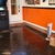 Colorful flakes being broadcast over wet ArmorClad epoxy for a decorative look on black epoxy