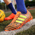 Orange triple stripe label print soccer shoe 06