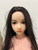 Close-up of the black-haired Scarlett WM Doll head showing facial features, eyes, lips, and wig styling.