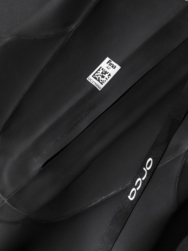 Close up of writing on back of Orca Zeal Perform saying 'BORN IN THE OCEAN, WILD & FREE'