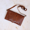 tan leather clutch bag with long shoulder strap