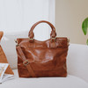 large leather tan tote with short handles and long crossbody strap
