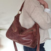 brown leather slouchy shoulder bag with zip front pockets and long adjustable strap