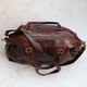 brown leather travel bag with zip closure