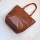 tan leather tote with zipped back pocket