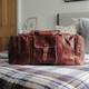 brown large leather travel bag with pockets and carry handles
