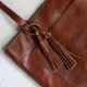 tan leather double tassel handbag charm on tote