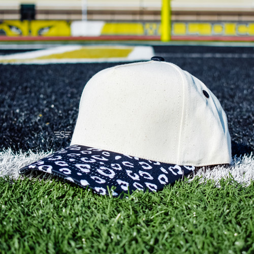 canvas leopard hat, navy leopard print cap, animal print bill hat, boutique trucker cap, neutral game-day hat, trendy canvas front cap, women’s leopard brim hat, spirit wear leopard cap, everyday neutral hat, game day, sports, high school, football, baseball, basketball, softball, school spirit