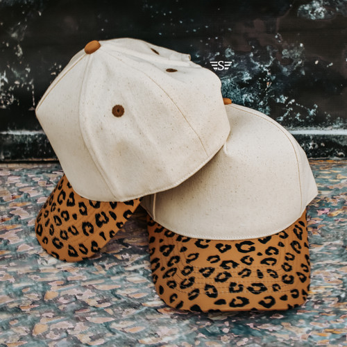 Magna Pony cap, ponytail hat, messy bun hat, women’s trucker cap, canvas trucker hat, leopard print bill hat, neutral western cap, boutique baseball hat, high ponytail hat, snapback ponytail cap, western boutique hat, Flying S Company cap, everyday women’s hat, animal print trucker cap, hair up hat