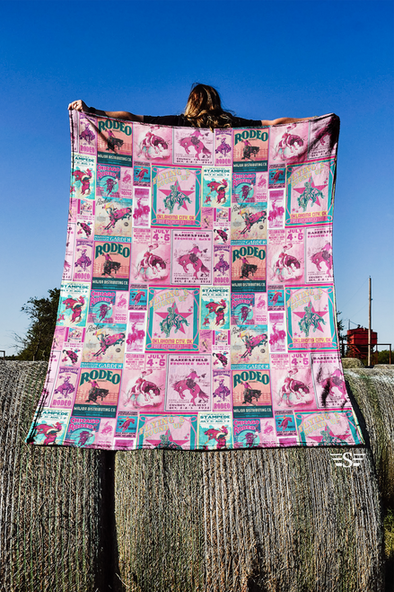 pink rodeo blanket, rodeo poster blanket, vintage rodeo throw, cowgirl blanket, pink western décor, barrel racing blanket, western statement throw, rodeo lifestyle blanket, western couch throw, cabin throw blanket, trailer décor blanket, dorm room blanket, ranch house décor, modern cowgirl décor, boutique western blanket, soft cozy throw, living room accent blanket, western bed blanket, rodeo gift for her, cowgirl gift idea, bold western blanket, pink home décor, ranch mom blanket