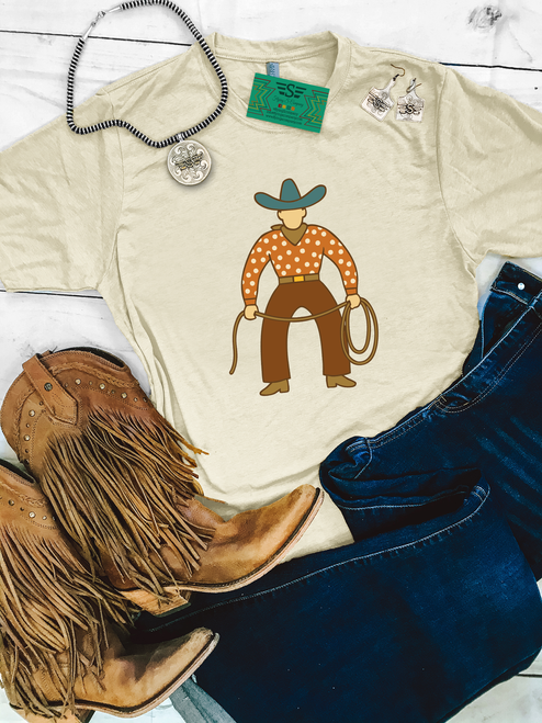 western graphic tee, cowboy graphic shirt, boutique western tee, retro cowboy shirt, western women’s tee, western unisex shirt, rodeo outfit shirt, western aesthetic tee, cowboy illustration shirt, soft cream western tee, western casual shirt, western boutique clothing, vintage cowboy tee, western outfit top, country western shirt, rodeo style graphic tee, western fashion tee