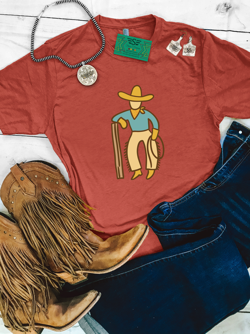 western graphic tee, cowboy graphic shirt, vintage western tee, rust western shirt, boutique western tee, cowboy illustration shirt, western casual tee, rodeo outfit shirt, western aesthetic tee, unisex western shirt, western fashion top, ranch style shirt, country western tee, relaxed fit western tee, western outfit staple, retro cowboy shirt, western boutique clothing