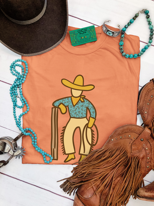 western graphic tee, cowboy graphic shirt, vintage western tee, rust western shirt, boutique western tee, cowboy illustration shirt, western casual tee, rodeo outfit shirt, western aesthetic tee, unisex western shirt, western fashion top, ranch style shirt, country western tee, relaxed fit western tee, western outfit staple, retro cowboy shirt, western boutique clothing