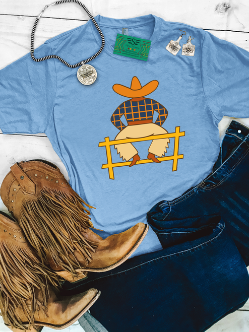 daydreaming cowboy shirt, western graphic tee, cowboy illustration shirt, washed denim western tee, boutique western shirt, vintage western graphic tee, western casual shirt, ranch style tee, country western shirt, western aesthetic tee, unisex western t shirt, western fashion top, relaxed fit western tee, fence sitting cowboy shirt, western boutique clothing