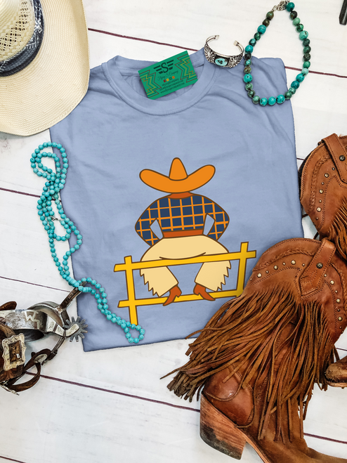 daydreaming cowboy shirt, western graphic tee, cowboy illustration shirt, washed denim western tee, boutique western shirt, vintage western graphic tee, western casual shirt, ranch style tee, country western shirt, western aesthetic tee, unisex western t shirt, western fashion top, relaxed fit western tee, fence sitting cowboy shirt, western boutique clothing