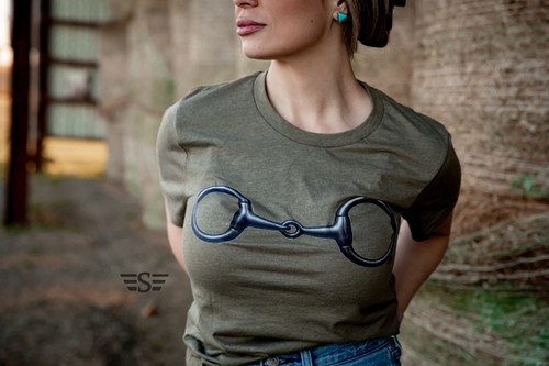 western graphic tee, cowgirl t shirt, snaffle bit shirt, western horse shirt, equestrian graphic tee, rodeo outfit top, ranch wear shirt, olive green western tee, horse lover gift, country western clothing, western boutique top, cowgirl outfit shirt, barn style apparel, rodeo fashion tee, minimalist western shirt, horse bit graphic tee, southern western style, women’s western t shirt, unisex western tee, western aesthetic clothing