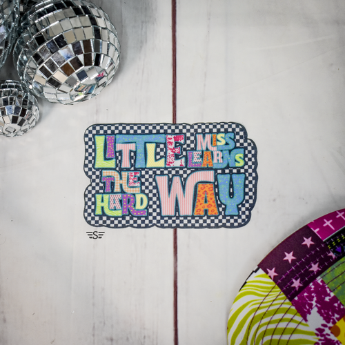 little miss learns the hard way, funny girl graphic, sassy quote shirt design, trendy boutique graphic, retro checkered design, colorful patchwork lettering, gen z humor shirt, sarcastic quote graphic, bold statement tee design, playful typography graphic, trendy western boutique graphic, quirky saying shirt, aesthetic mixed pattern design, fun graphic tee design, humorous lifestyle apparel, boutique statement graphic, colorful retro lettering, trending phrase design, funny relatable quote, modern boutique apparel design, cute sarcastic graphic, vibrant letter design, checkered background graphic, trendy fashion graphic, statement quote design