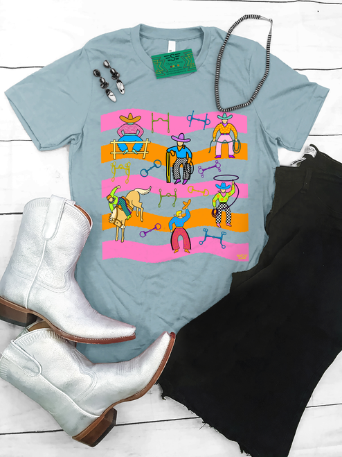 Bright, bold, and full of western spirit, our Life of a Cowboy Vibrant Graphic Tee celebrates the grit, tradition, and excitement of cowboy life. Featuring colorful hand-drawn rodeo scenes—including bronc riding, roping, ranch work, fencing, and western tack—this eye-catching design is finished with playful retro-inspired stripes that make it a true statement piece.
Printed on your choice of Softstyle, Comfort Colors, or a Muscle Tank, this tee is incredibly soft and perfect for rodeos, county fairs, livestock shows, country concerts, or everyday western style. Whether you grew up in the arena or simply love the western way of life, this shirt brings cowboy culture to life with a fun, artistic twist.