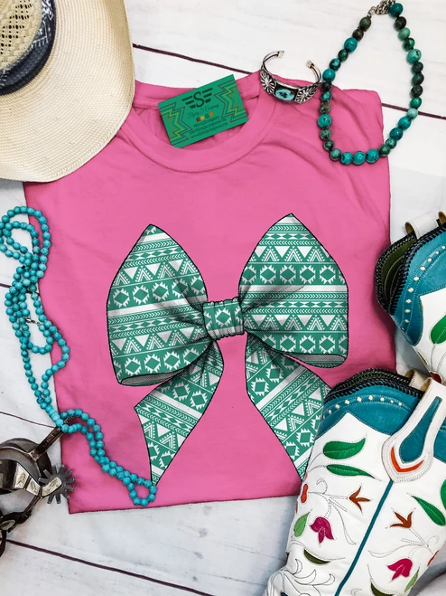 Aztec turquoise coquette bow shirt, turquoise bow shirt, western bow shirt, coquette western shirt, Aztec bow graphic tee, western graphic tee, cowgirl graphic shirt, turquoise western shirt, western coquette tee, southwestern bow shirt, western women’s tee, cowgirl shirt, Aztec print shirt, western boutique shirt, trendy western tee, western bow graphic, turquoise graphic tee, rodeo shirt, stock show shirt, western fashion, western apparel, Flying S Company