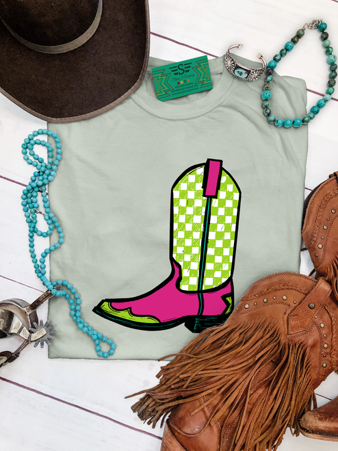 Vibrant check boot graphic shirt, checkered cowboy boot shirt, green check boot shirt, pink cowboy boot graphic tee, colorful western shirt, checkered western boot, western boot graphic tee, bright cowgirl shirt, retro cowboy boot shirt, western boutique women's shirt, cowgirl graphic tee, pink and green boot shirt, trendy western shirt, western rodeo shirt, stock show graphic tee, cowgirl fashion shirt, colorful western clothing, checkered boot graphic tee, cowboy boot shirt, retro western fashion, neon western graphic tee, western boutique clothing, Flying S Company