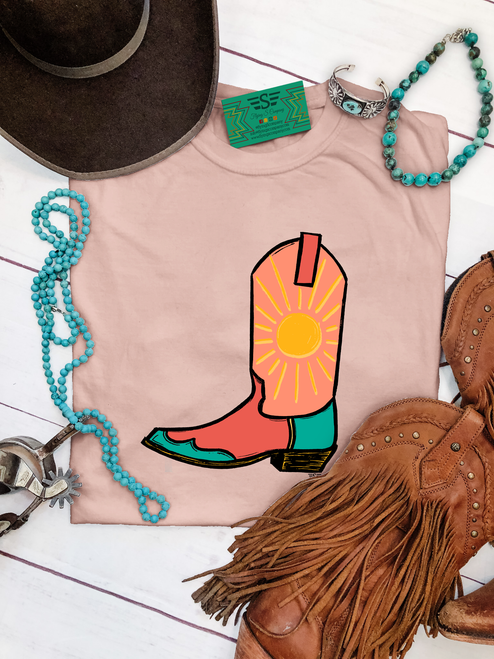 Vibrant sun boot graphic shirt, sun cowboy boot shirt, western graphic tee for women, colorful cowboy boot shirt, sunshine western graphic tee, sunburst cowboy boot shirt, retro western women's shirt, peach cowboy boot graphic tee, coral western graphic shirt, turquoise cowboy boot shirt, sunset western graphic tee, funky western women's shirt, vibrant cowgirl shirt, colorful western boutique tee, retro cowgirl fashion, sunshine cowgirl graphic tee, trendy western apparel, women's cowboy boot shirt, rodeo graphic tee, stock show shirt, country concert outfit, bright western graphic shirt, summer western tee, western boutique clothing, Flying S Company