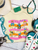 Bright, bold, and full of western spirit, our Life of a Cowboy Vibrant Graphic Tee celebrates the grit, tradition, and excitement of cowboy life. Featuring colorful hand-drawn rodeo scenes—including bronc riding, roping, ranch work, fencing, and western tack—this eye-catching design is finished with playful retro-inspired stripes that make it a true statement piece.
Printed on your choice of Softstyle, Comfort Colors, or a Muscle Tank, this tee is incredibly soft and perfect for rodeos, county fairs, livestock shows, country concerts, or everyday western style. Whether you grew up in the arena or simply love the western way of life, this shirt brings cowboy culture to life with a fun, artistic twist.