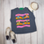 Bright, bold, and full of western spirit, our Life of a Cowboy Vibrant Graphic Tee celebrates the grit, tradition, and excitement of cowboy life. Featuring colorful hand-drawn rodeo scenes—including bronc riding, roping, ranch work, fencing, and western tack—this eye-catching design is finished with playful retro-inspired stripes that make it a true statement piece.
Printed on your choice of Softstyle, Comfort Colors, or a Muscle Tank, this tee is incredibly soft and perfect for rodeos, county fairs, livestock shows, country concerts, or everyday western style. Whether you grew up in the arena or simply love the western way of life, this shirt brings cowboy culture to life with a fun, artistic twist.