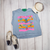 Bright, bold, and full of western spirit, our Life of a Cowboy Vibrant Graphic Tee celebrates the grit, tradition, and excitement of cowboy life. Featuring colorful hand-drawn rodeo scenes—including bronc riding, roping, ranch work, fencing, and western tack—this eye-catching design is finished with playful retro-inspired stripes that make it a true statement piece.
Printed on your choice of Softstyle, Comfort Colors, or a Muscle Tank, this tee is incredibly soft and perfect for rodeos, county fairs, livestock shows, country concerts, or everyday western style. Whether you grew up in the arena or simply love the western way of life, this shirt brings cowboy culture to life with a fun, artistic twist.