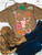 floral steer shirt, floral steer skull shirt, western floral shirt, cow skull graphic tee, western graphic tee, cowgirl graphic shirt, colorful western shirt, pink western shirt, floral cow skull tee, steer skull graphic shirt, western wildflower shirt, boho western shirt, women’s western graphic tee, western boutique shirt, cowgirl floral shirt, rodeo graphic tee, western concert shirt, bright western shirt, trendy cowgirl shirt, western apparel