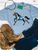 blue painted pony shirt, blue horse graphic tee, painted horse shirt, western horse shirt, turquoise horse graphic tee, cowgirl graphic shirt, hand painted horse shirt, blue and white horse shirt, western graphic tee for women, horse lover shirt, artistic horse graphic tee, running horse shirt, colorful western shirt, western boutique shirt, blue western graphic tee, equestrian graphic shirt, rodeo graphic tee, stock show shirt, western concert shirt, trendy cowgirl shirt, country graphic tee, western fashion, painted pony graphic tee