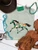 Brushstroke painted pony graphic shirt, brushstroke horse graphic tee, colorful painted pony shirt, western horse graphic shirt, hand painted horse shirt, artistic western graphic tee, turquoise and coral horse shirt, colorful western shirt for women, painted pony western tee, running horse graphic shirt, brushstroke horse design, western boutique clothing, cowgirl graphic tee, abstract painted horse shirt, multicolor horse graphic tee, western women's apparel, horse lover graphic shirt, trendy western fashion, colorful cowgirl shirt, rodeo graphic tee, stock show shirt, modern western graphic shirt, western art inspired tee, boho western shirt, Flying S Company