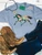 Brushstroke painted pony graphic shirt, brushstroke horse graphic tee, colorful painted pony shirt, western horse graphic shirt, hand painted horse shirt, artistic western graphic tee, turquoise and coral horse shirt, colorful western shirt for women, painted pony western tee, running horse graphic shirt, brushstroke horse design, western boutique clothing, cowgirl graphic tee, abstract painted horse shirt, multicolor horse graphic tee, western women's apparel, horse lover graphic shirt, trendy western fashion, colorful cowgirl shirt, rodeo graphic tee, stock show shirt, modern western graphic shirt, western art inspired tee, boho western shirt, Flying S Company