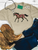 Floral painted pony graphic shirt, floral horse graphic tee, pink flower horse shirt, western floral horse shirt, painted pony women's tee, cowgirl floral graphic shirt, western horse graphic tee, floral painted horse design, pink floral pony shirt, hand painted horse graphic tee, western boutique women's shirt, horse lover graphic tee, girly western shirt, floral cowgirl tee, boho western graphic shirt, colorful horse graphic tee, western fashion for women, running horse graphic shirt, floral horse illustration tee, western rodeo shirt, stock show graphic tee, rustic floral horse shirt, trendy cowgirl graphic tee, pink flower western shirt, equestrian graphic tee, western boutique clothing, Flying S Company