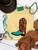 Floral boot graphic shirt, floral cowboy boot shirt, western floral graphic tee, colorful cowboy boot shirt, retro western shirt, vintage floral boot tee, turquoise cowboy boot shirt, western women's graphic tee, cowgirl floral shirt, funky western graphic tee, colorful western shirt, retro cowgirl shirt, western boutique clothing, bright western graphic tee, floral western shirt, boho western shirt, rodeo graphic tee, stock show shirt, country concert outfit, western fashion for women, colorful cowgirl clothing, hand drawn cowboy boot shirt, Flying S Company