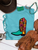 Floral boot graphic shirt, floral cowboy boot shirt, western floral graphic tee, colorful cowboy boot shirt, retro western shirt, vintage floral boot tee, turquoise cowboy boot shirt, western women's graphic tee, cowgirl floral shirt, funky western graphic tee, colorful western shirt, retro cowgirl shirt, western boutique clothing, bright western graphic tee, floral western shirt, boho western shirt, rodeo graphic tee, stock show shirt, country concert outfit, western fashion for women, colorful cowgirl clothing, hand drawn cowboy boot shirt, Flying S Company
