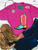Howdy boot graphic shirt, howdy cowboy boot shirt, western boot graphic tee, colorful cowboy boot shirt, howdy western shirt, retro cowboy boot tee, turquoise cowboy boot shirt, pink howdy shirt, western graphic shirt, cowgirl graphic tee, western boutique women's shirt, colorful western shirt, howdy graphic tee, retro western graphic shirt, bold western shirt, rodeo graphic tee, stock show shirt, country concert shirt, funky western tee, western fashion shirt, cowboy boot graphic tee, western women's clothing, vintage inspired western shirt, Flying S Company