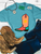 Vibrant sun boot graphic shirt, sun cowboy boot shirt, western graphic tee for women, colorful cowboy boot shirt, sunshine western graphic tee, sunburst cowboy boot shirt, retro western women's shirt, peach cowboy boot graphic tee, coral western graphic shirt, turquoise cowboy boot shirt, sunset western graphic tee, funky western women's shirt, vibrant cowgirl shirt, colorful western boutique tee, retro cowgirl fashion, sunshine cowgirl graphic tee, trendy western apparel, women's cowboy boot shirt, rodeo graphic tee, stock show shirt, country concert outfit, bright western graphic shirt, summer western tee, western boutique clothing, Flying S Company