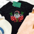 graphic tee, t-shirt, shirt, christmas, holiday, festive, festivities, santa, bad santa, rocker, rock n roll, rock music
