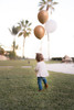 little girl walking with diamante teddy and balloons