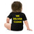 #Cancelaundryday Baby One-Piece - Worn by Baby Boy (Back View). Cute baby boy with longer hair wearing a black onesie with 'We Deliver Clean!' printed in yellow on the back.